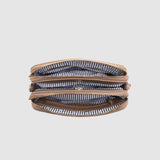 Three layered zipper pouch with striped pattern on a light gray background