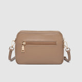 Beige crossbody bag on a light gray background