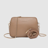 Beige handbag with chain detail on a light gray background