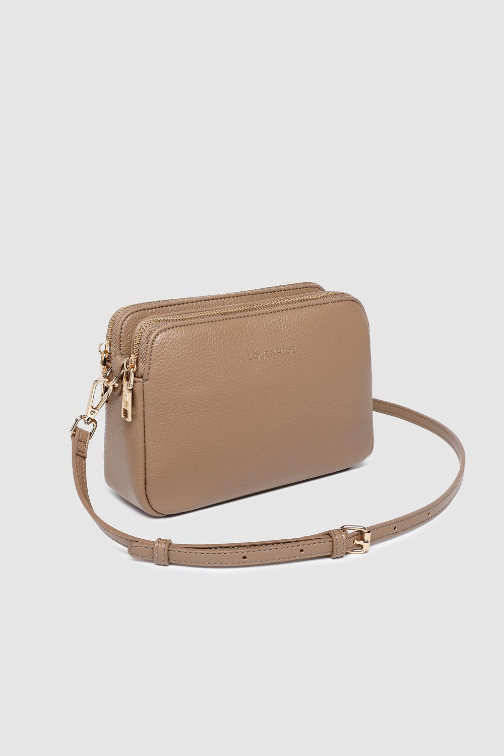Beige crossbody bag on a light gray background