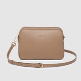 Beige crossbody bag on a light gray background
