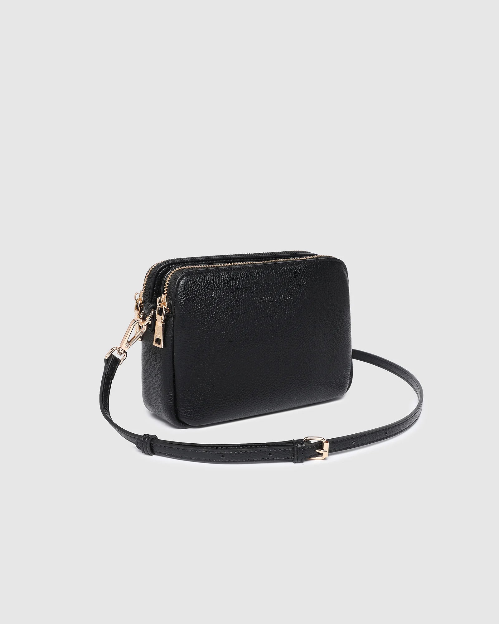 The Louenhide Elle Crossbody Bag is the elevated staple your wardrobe has been waiting for. Designed with a compact rectangular silhouette, this triple compartment crossbody bag keeps your essentials streamlined and organized without compromising style.   To switch up your look with ease, opt for the gold chain strap to elevate your dressier on-the-go moments or swap to the matching faux leather strap for an casual feel.  Adorned with light gold hardware, this multi-zipper crossbody bag is designed to carry