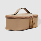 Beige cosmetic bag with a tassel on a light gray background