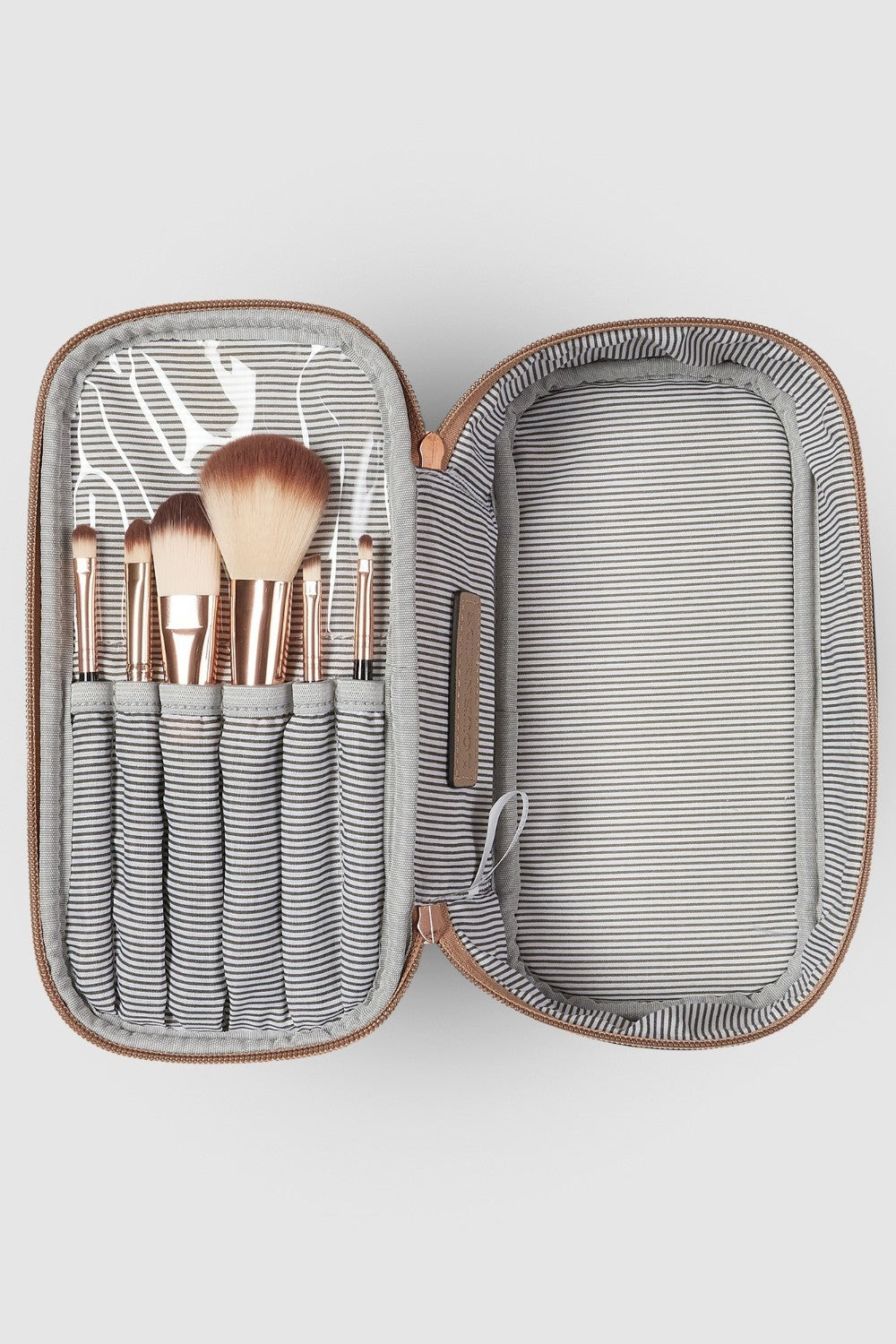 Makeup brushes in a striped case on a white background