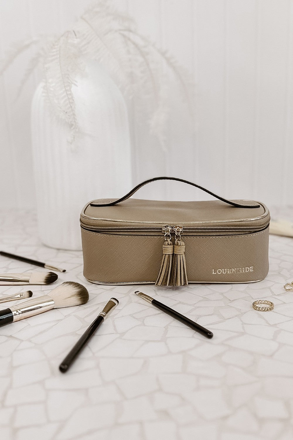 Makeup bag with brushes on a textured surface