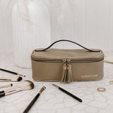 Makeup bag with brushes on a textured surface