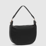 A black pebbled leather crescent-shaped shoulder bag with a single shoulder strap and gold-tone hardware, shown against a light gray background.
