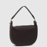 A dark brown pebbled leather crescent-shaped shoulder bag with a single shoulder strap and gold-tone hardware, shown against a light gray background.
