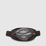 A dark brown leather belt bag shown from the top, open to reveal a striped interior lining, set against a solid light gray background.