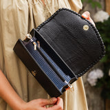 The Louenhide Harlow Crossbody Bag is a timeless, year-round wardrobe staple featuring a subtle woven vegan leather trim. Whether you are heading to brunch or afternoon drinks, the detachable and adjustable crossbody strap allows you to seamlessly transition the Harlow from crossbody to clutch. With the two thoughtfully designed compartments and large zip pocket, organize your daily essentials with ease. Designed with an envelope silhouette to pair seamlessly with your wardrobe.