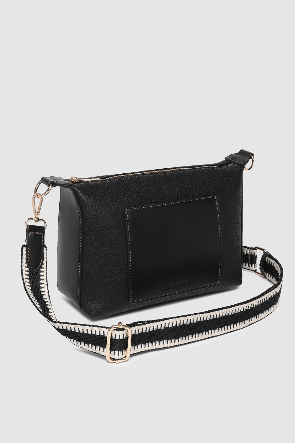 Black handbag with a strap on a light gray background