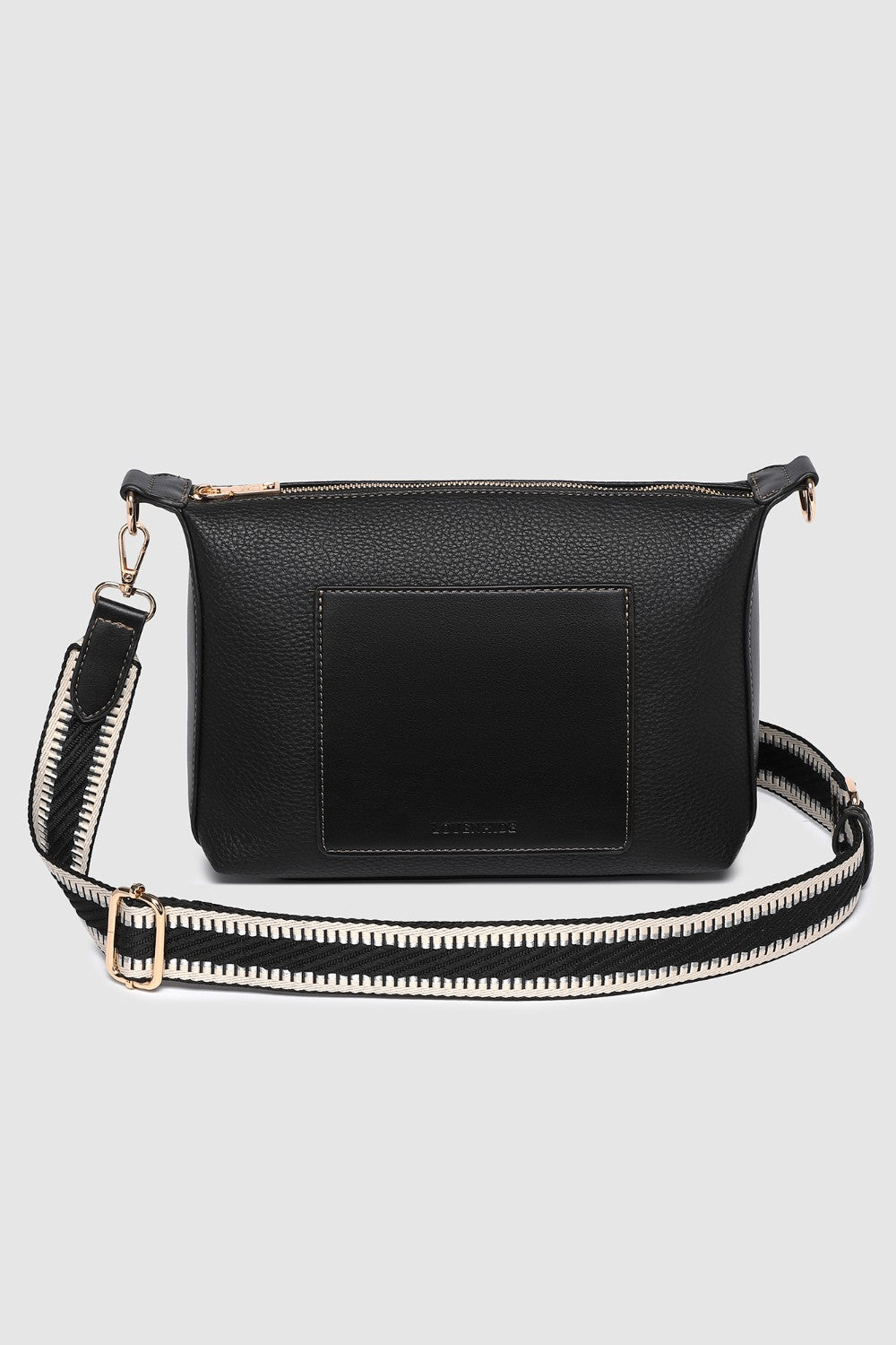 Black pleather crossbody bag with a strap on a light gray background