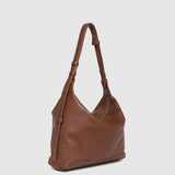 Brown leather handbag on a light gray background