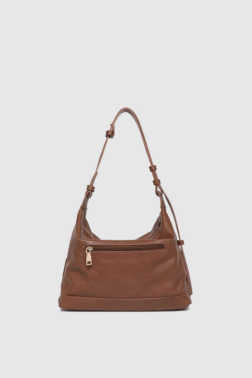 Brown leather handbag on a light gray background