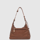 Brown leather handbag on a light gray background
