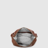Brown leather handbag with a striped lining on a light gray background