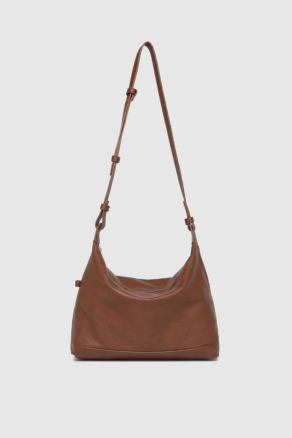 Brown leather handbag with a strap on a white background