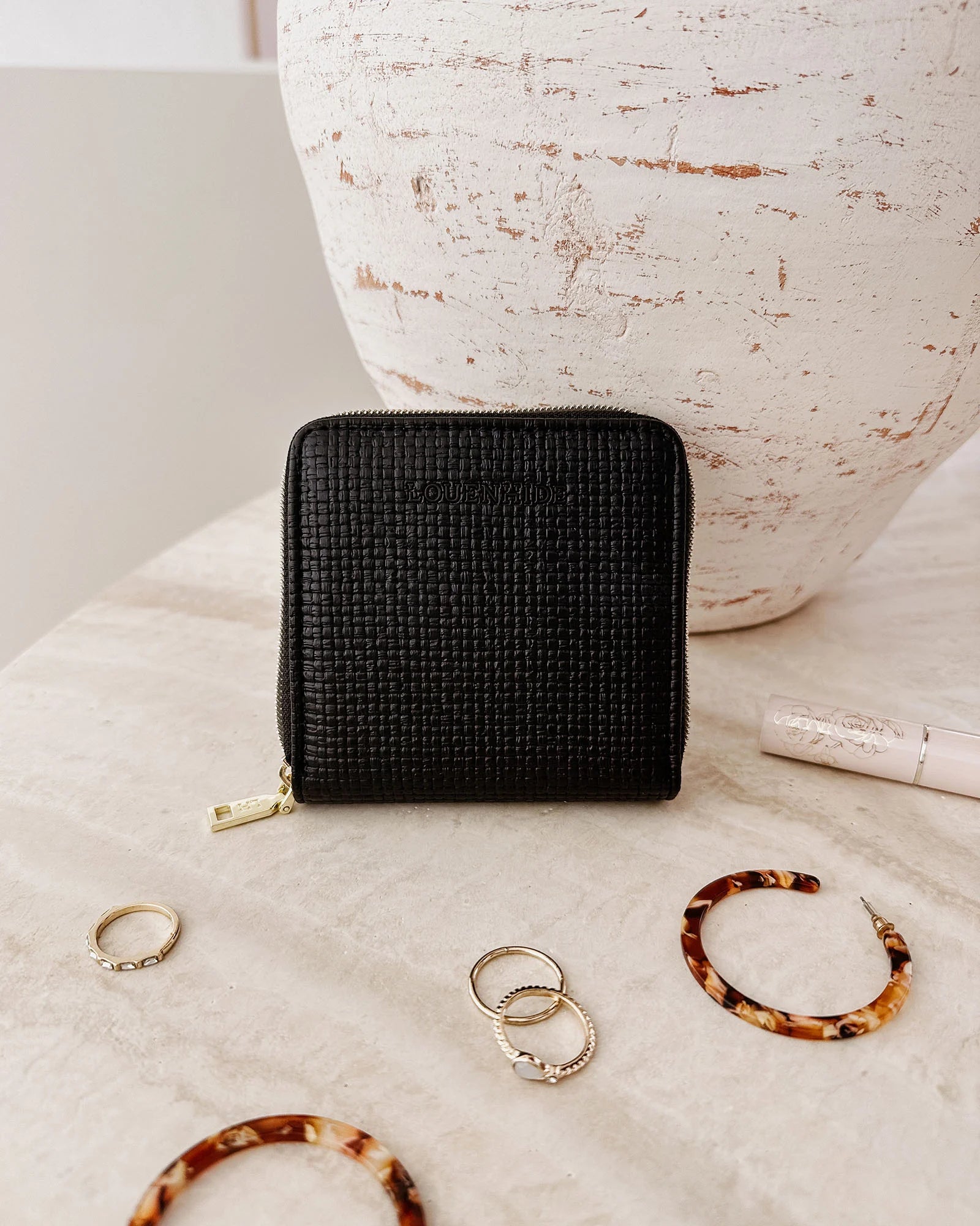 The Louenhide Juniper Jewelry Case is ideal for those who appreciate the finer details in their jewelry storage. Designed with your dynamic lifestyle in mind, this jewellery wallet is compact and portable. Whether placed on your vanity at home or tucked into your luggage for travel, the Juniper ensures your favourite pieces are protected wherever you go. Organize your pieces with the two press stud hooks, slip pocket, drawstring bag, ring roll and earring press stud band. Structured and protected, th