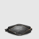 A black leather belt bag shown from the top, open to reveal a black and gray patterned interior lining, set against a solid light gray background.