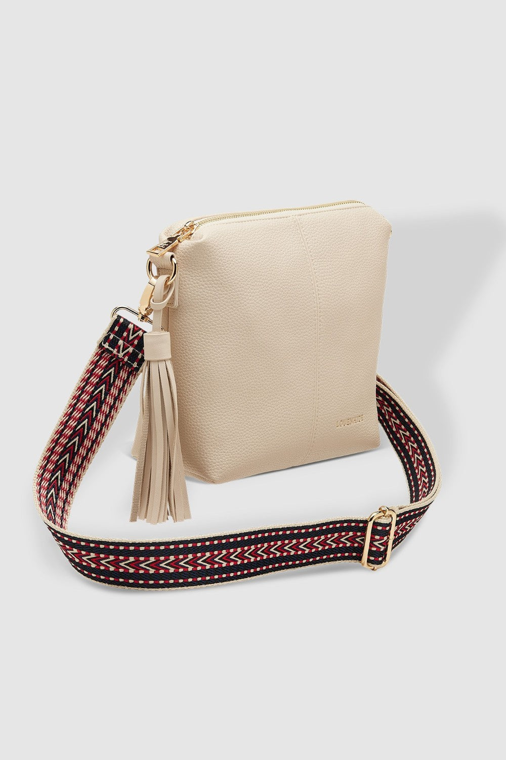Beige handbag with a decorative strap on a white background