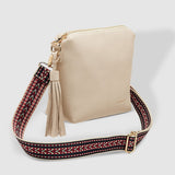 Beige handbag with a decorative strap on a white background