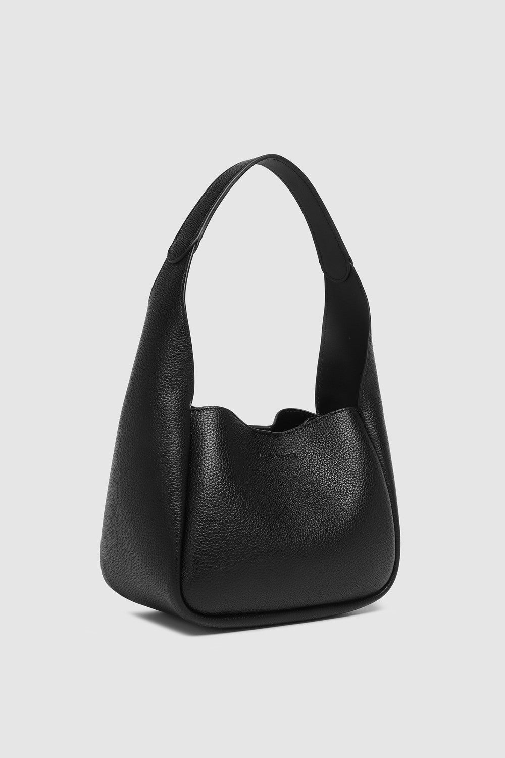 Black pleather handbag on a light gray background