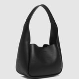 Black pleather handbag on a light gray background