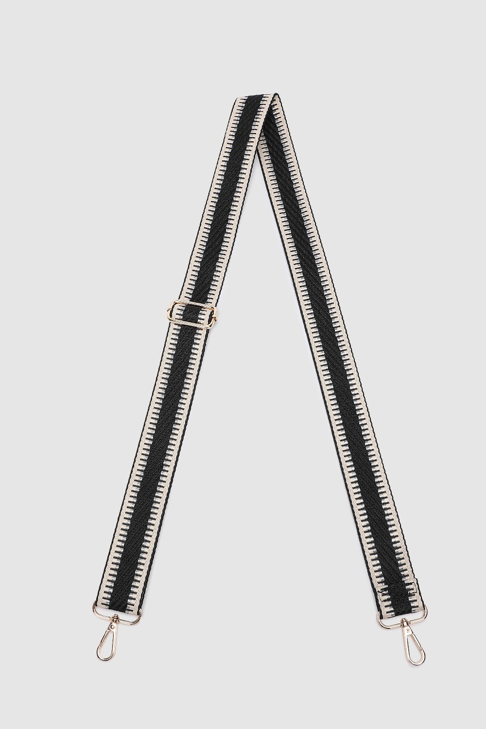 Black and white striped bag strap on a light gray background