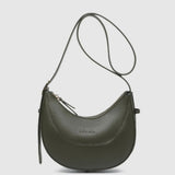 An olive green crescent-shaped leather shoulder bag with a thin matching shoulder strap, shown against a light gray background.