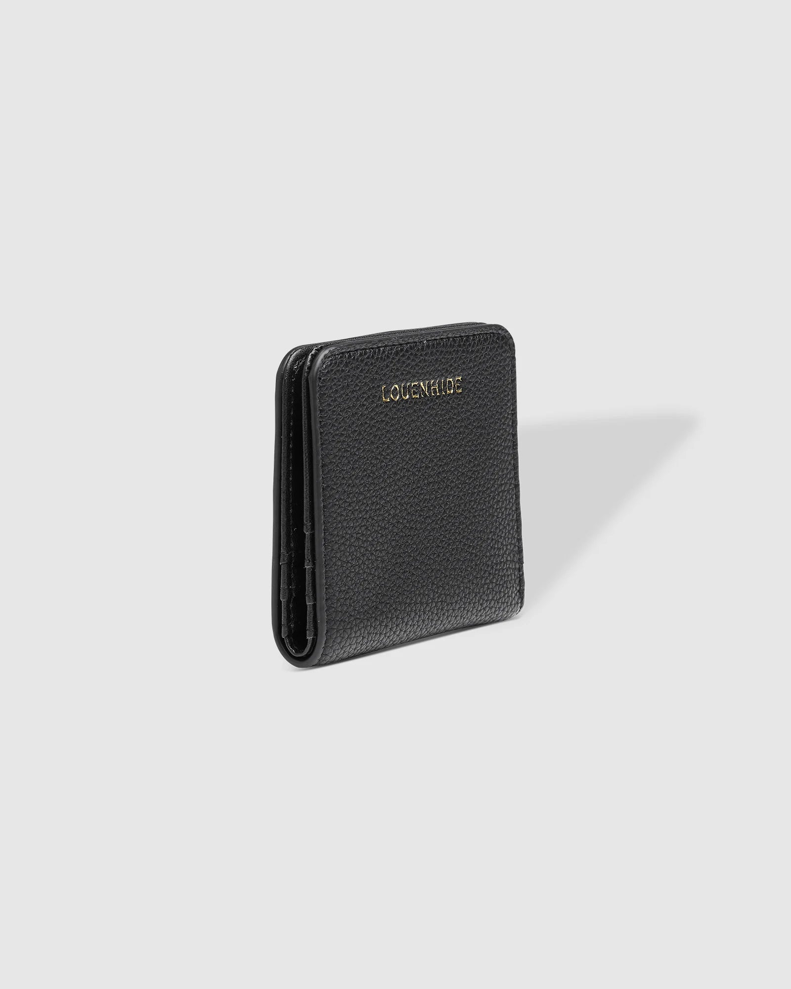 The Louenhide Lily Wallet is a must-have for the minimalist seeking a sleek and efficient way to carry their essentials. The ultimate accessory for compact organization and style, this refined design offers 7 cardholders and a secure zip pocket, so you won’t be fumbling through your wallet to find the right card or your loose change. Crafted from a luxe vegan leather, the Lily Wallet boasts a slim profile that easily slips into any pocket or bag without adding unnecessary bulk.