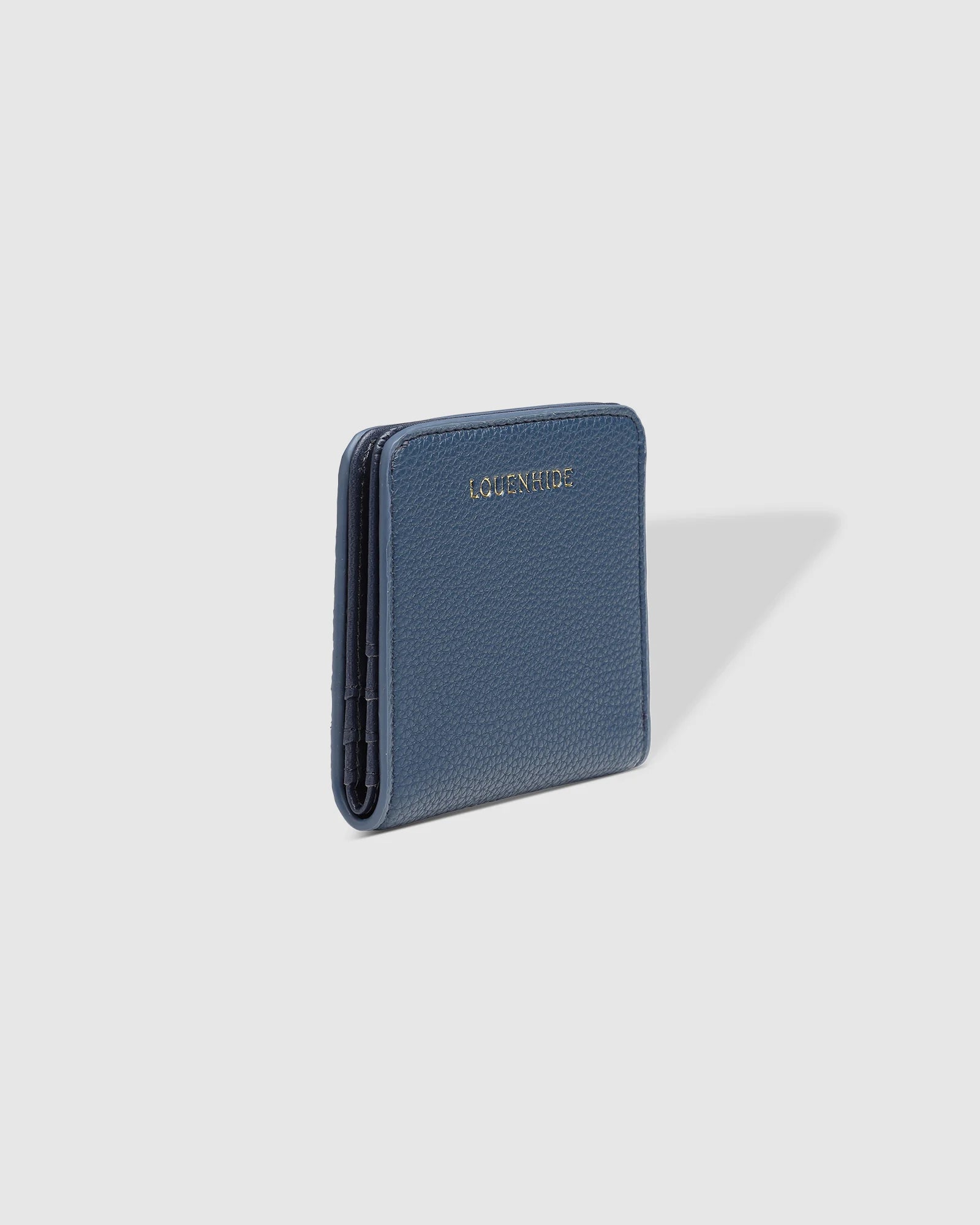 The Louenhide Lily Wallet is a must-have for the minimalist seeking a sleek and efficient way to carry their essentials. The ultimate accessory for compact organization and style, this refined design offers 7 cardholders and a secure zip pocket, so you won’t be fumbling through your wallet to find the right card or your loose change. Crafted from a luxe vegan leather, the Lily Wallet boasts a slim profile that easily slips into any pocket or bag without adding unnecessary bulk.