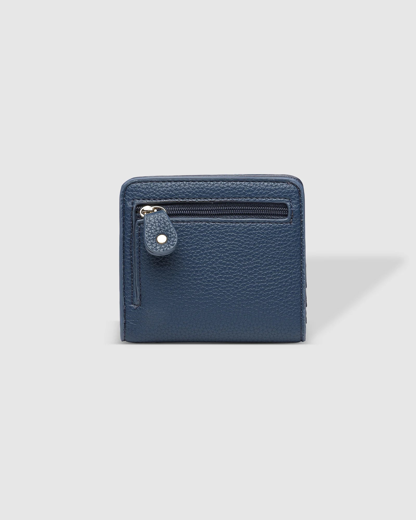 The Louenhide Lily Wallet is a must-have for the minimalist seeking a sleek and efficient way to carry their essentials. The ultimate accessory for compact organization and style, this refined design offers 7 cardholders and a secure zip pocket, so you won’t be fumbling through your wallet to find the right card or your loose change. Crafted from a luxe vegan leather, the Lily Wallet boasts a slim profile that easily slips into any pocket or bag without adding unnecessary bulk.