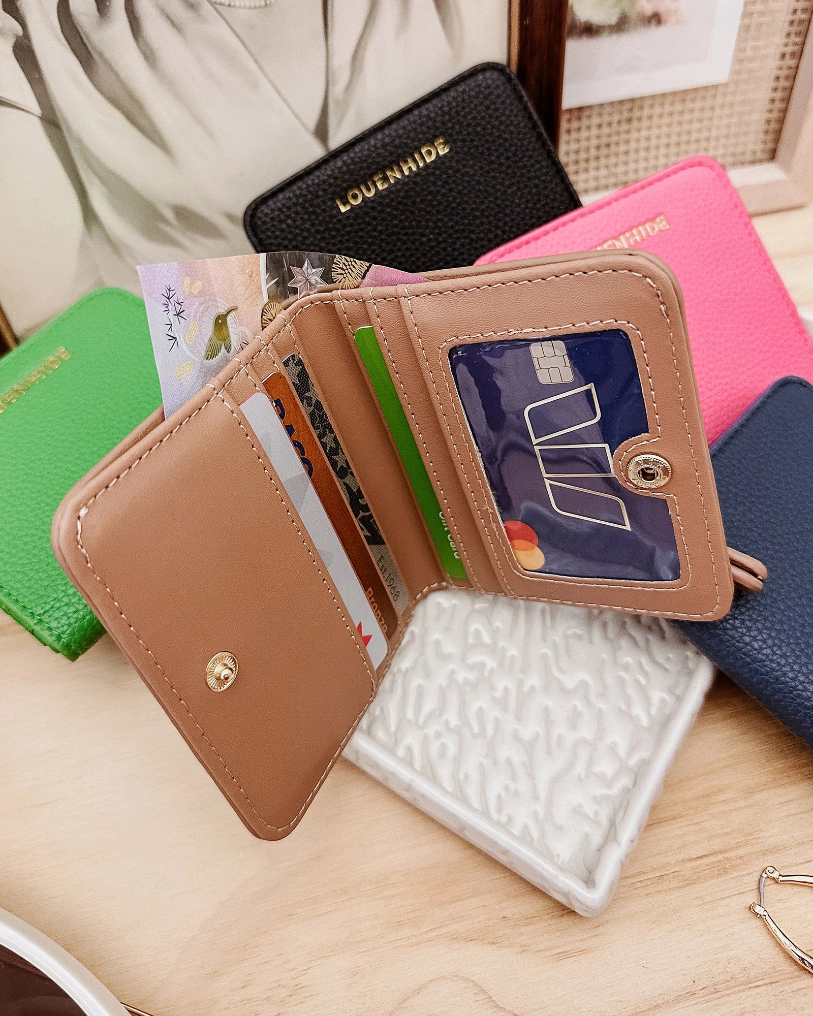 The Louenhide Lily Wallet is a must-have for the minimalist seeking a sleek and efficient way to carry their essentials. The ultimate accessory for compact organization and style, this refined design offers 7 cardholders and a secure zip pocket, so you won’t be fumbling through your wallet to find the right card or your loose change. Crafted from a luxe vegan leather, the Lily Wallet boasts a slim profile that easily slips into any pocket or bag without adding unnecessary bulk.