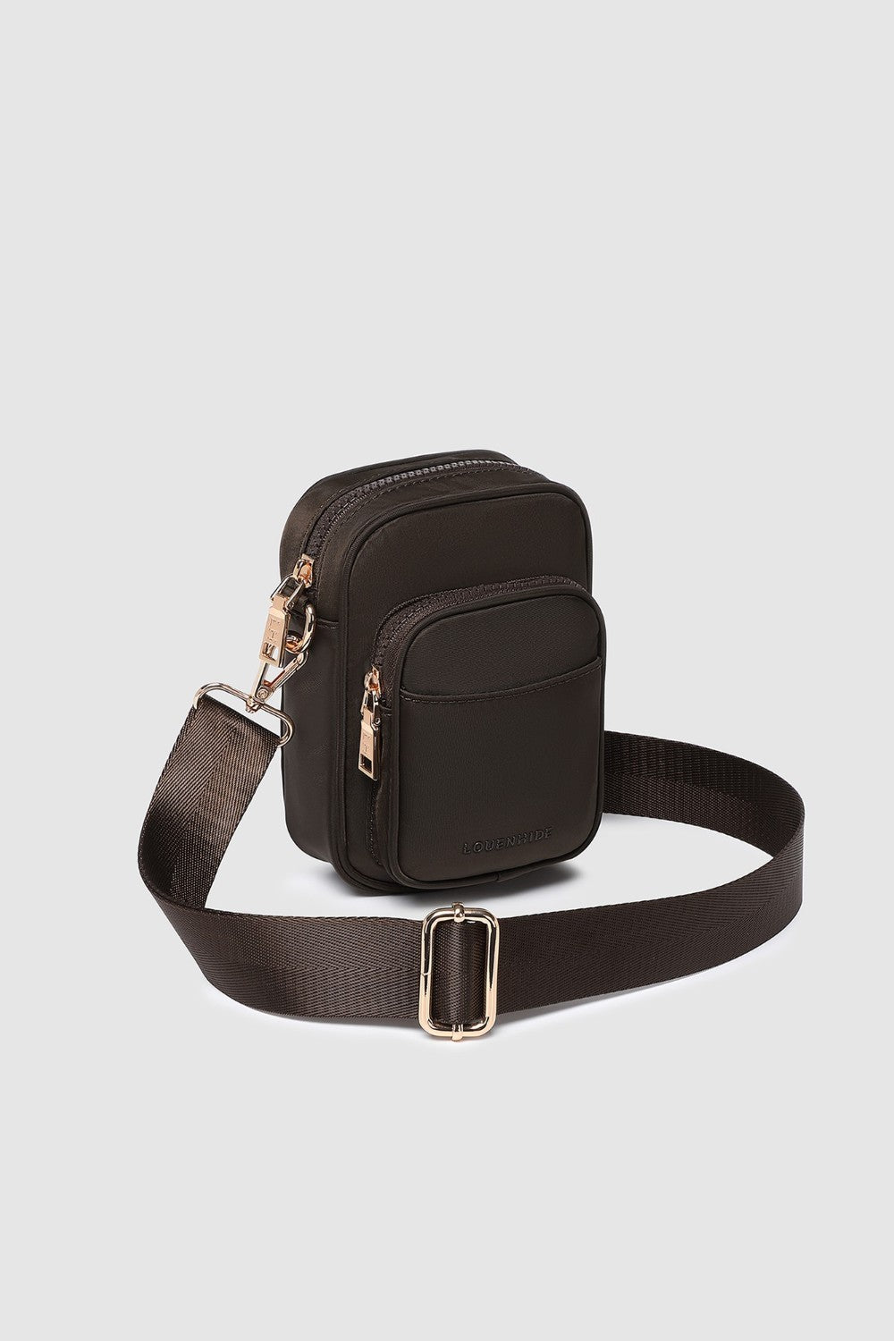 Brown crossbody bag with a strap on a light gray background