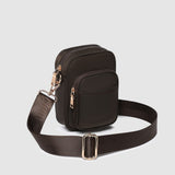 Brown crossbody bag with a strap on a light gray background