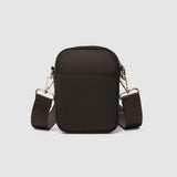 Brown crossbody bag with adjustable strap on a light gray background