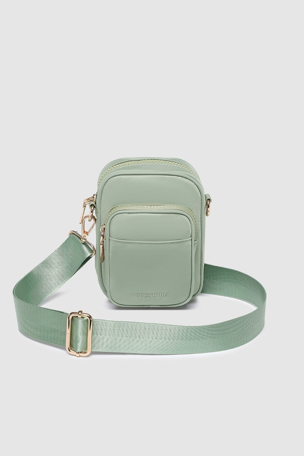 Green crossbody bag on a light gray background