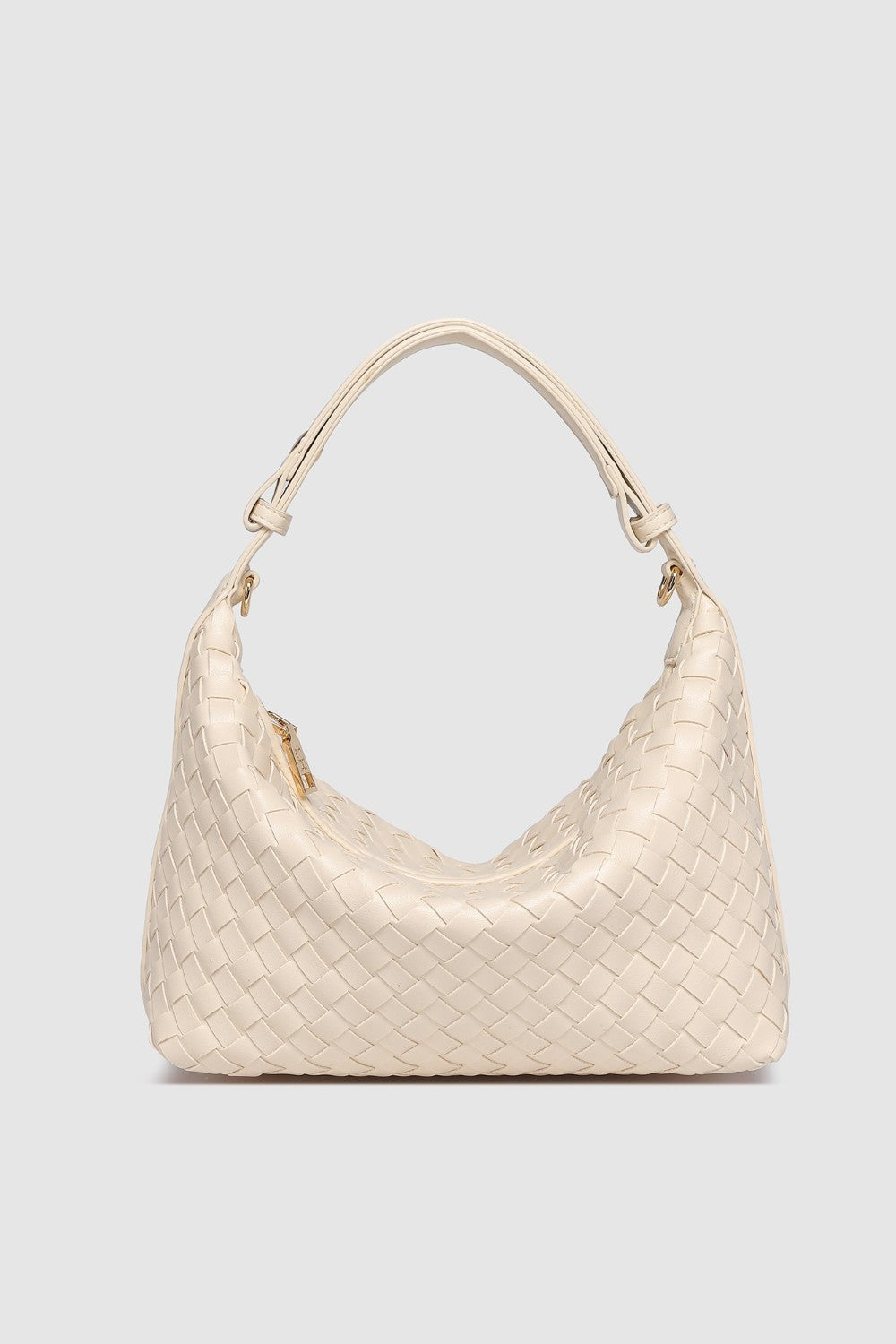 Beige woven handbag on a light gray background