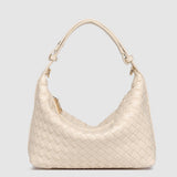 Beige woven handbag on a light gray background