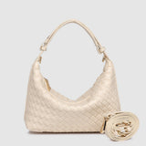 Beige woven handbag with extra strap on a light gray background