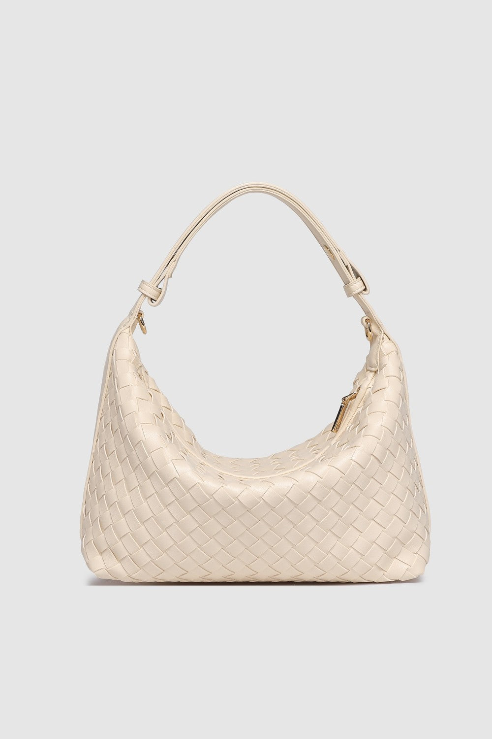 Beige woven handbag on a light gray background