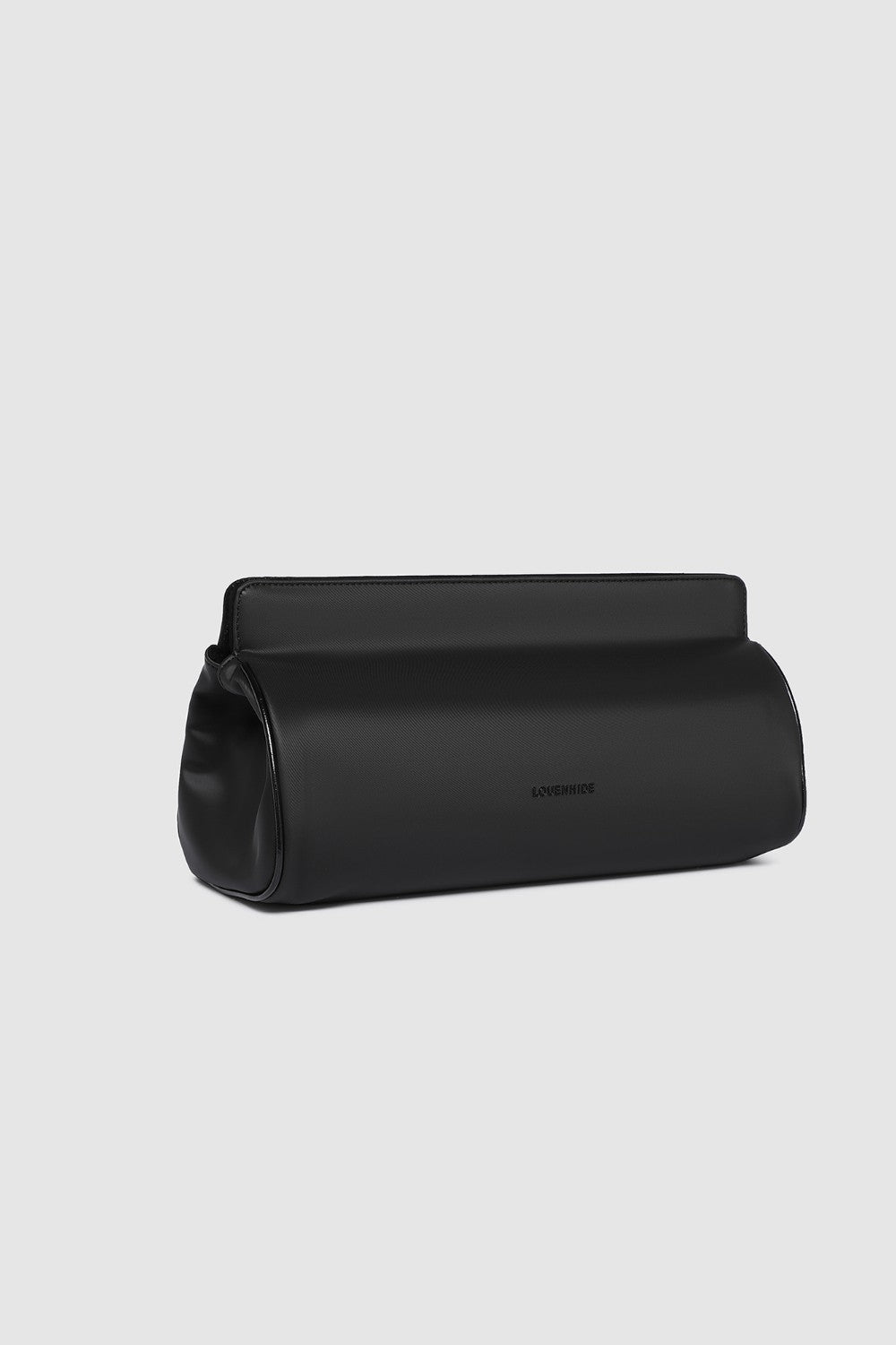 Black pleather bag on a light gray background