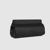 Black pleather bag on a light gray background