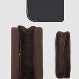 Brown pleather travel case on a light gray background