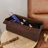 Brown pleather storage case with hair care products on a wooden stool next to a brown leather chair.