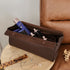 Brown pleather storage case with hair care products on a wooden stool next to a brown leather chair.