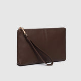 A dark brown pebbled leather wristlet clutch with a matching wrist strap and gold-tone zipper hardware, shown on a light gray background.