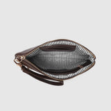 An open dark brown leather zip-around wristlet clutch with a striped black and white interior lining, shown against a light gray background.