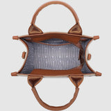 Brown handbag with striped interior on a light gray background
