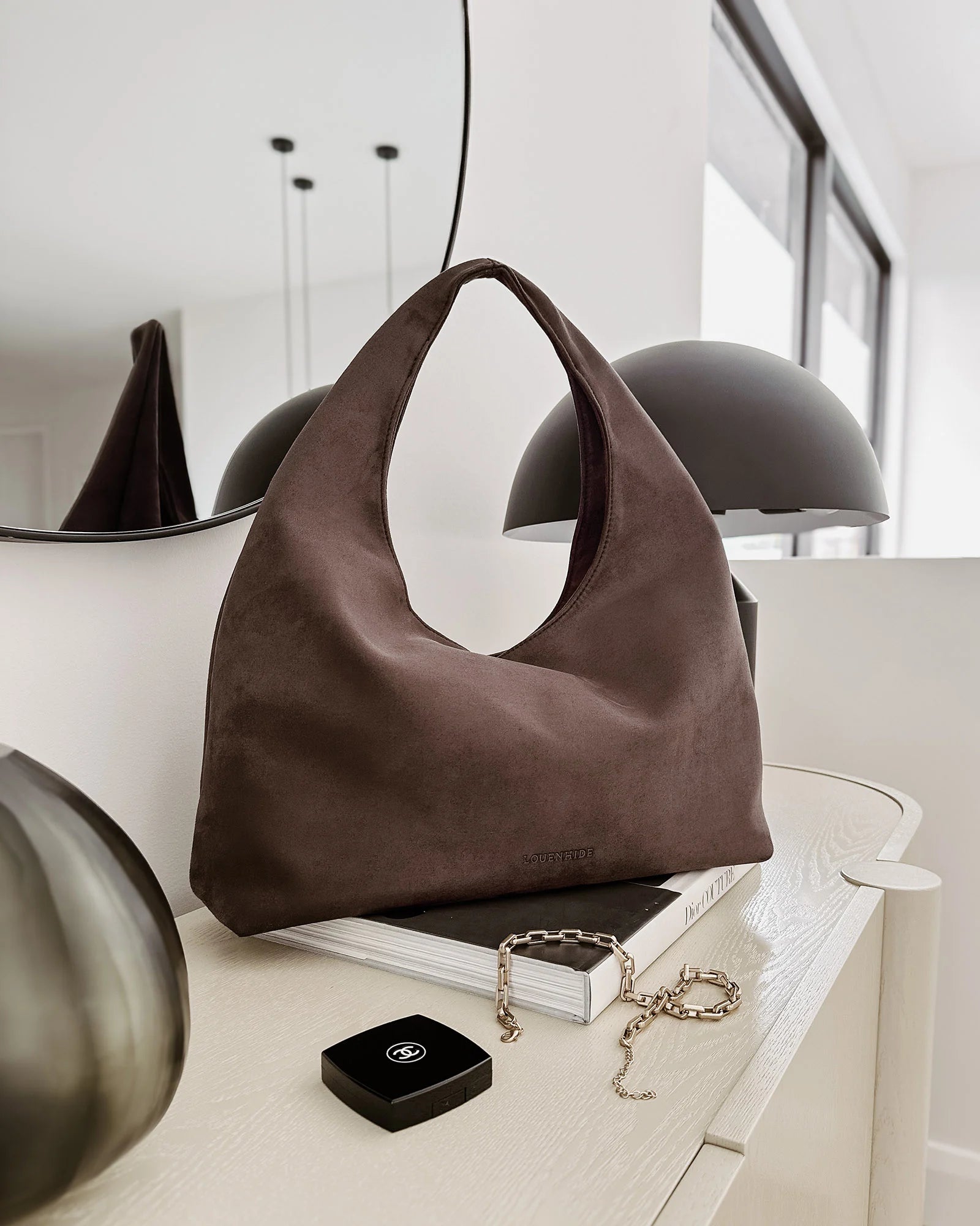 The Louenhide Monaco Shoulder Bag is the it-girl bag and our top seller.  Whether it's a day at the office, a girls' lunch, or a casual outing, the Monaco is suited for any occasion. Her slouchy, minimalistic design adds a soft yet sleek element to the shoulder bags exterior while also allowing ample interior space to fit your everyday essentials and more. The seamless teardrop silhouette sits comfortably over the shoulder as you go about your day. Elevate your style and invest in the must-have Monaco Shoul